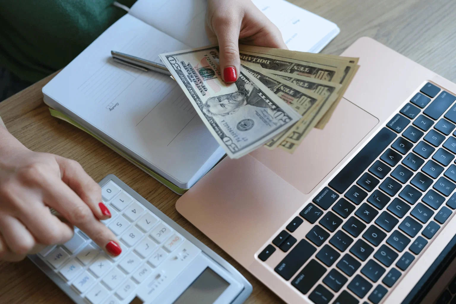 Person using calculator and laptop to plan home budget | Common First-Time Homebuyer Mistakes in Pleasanton