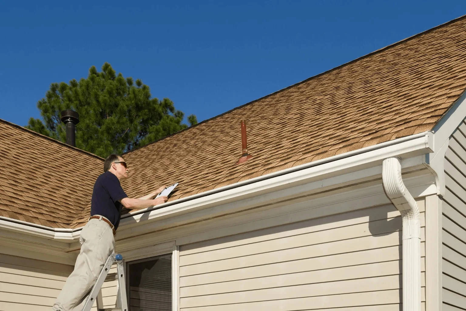Home inspector evaluating a house exterior