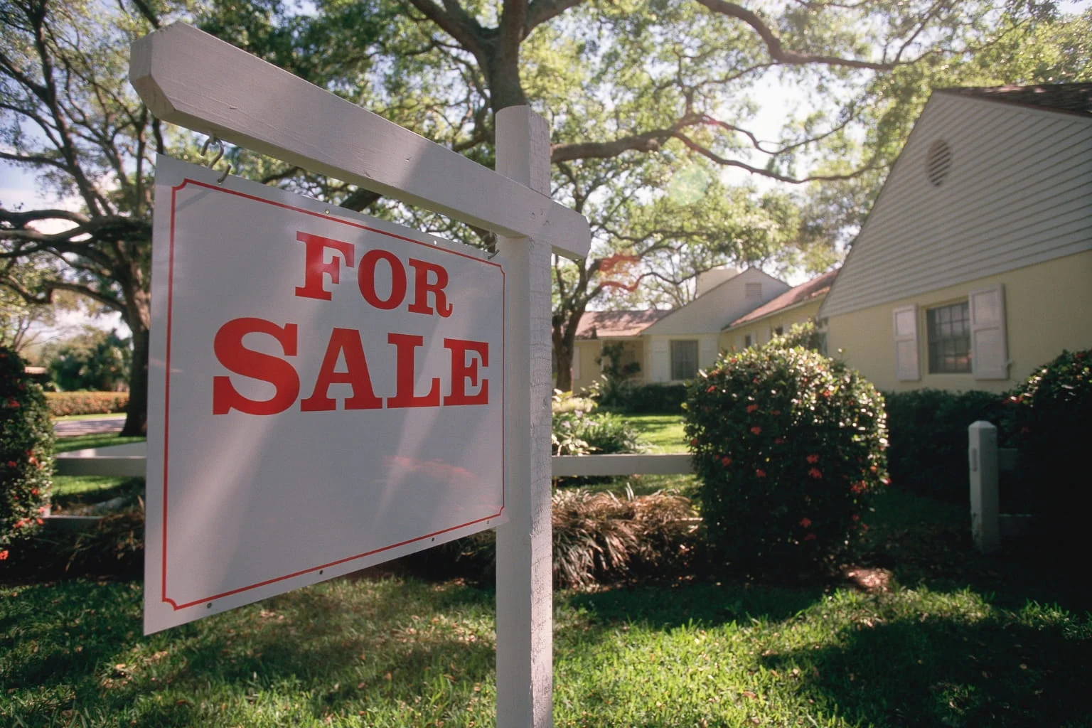House for sale sign in front of home