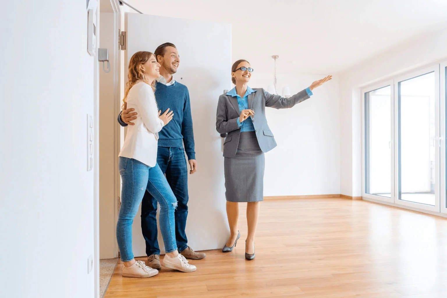 Realtor showing a modern home to a couple