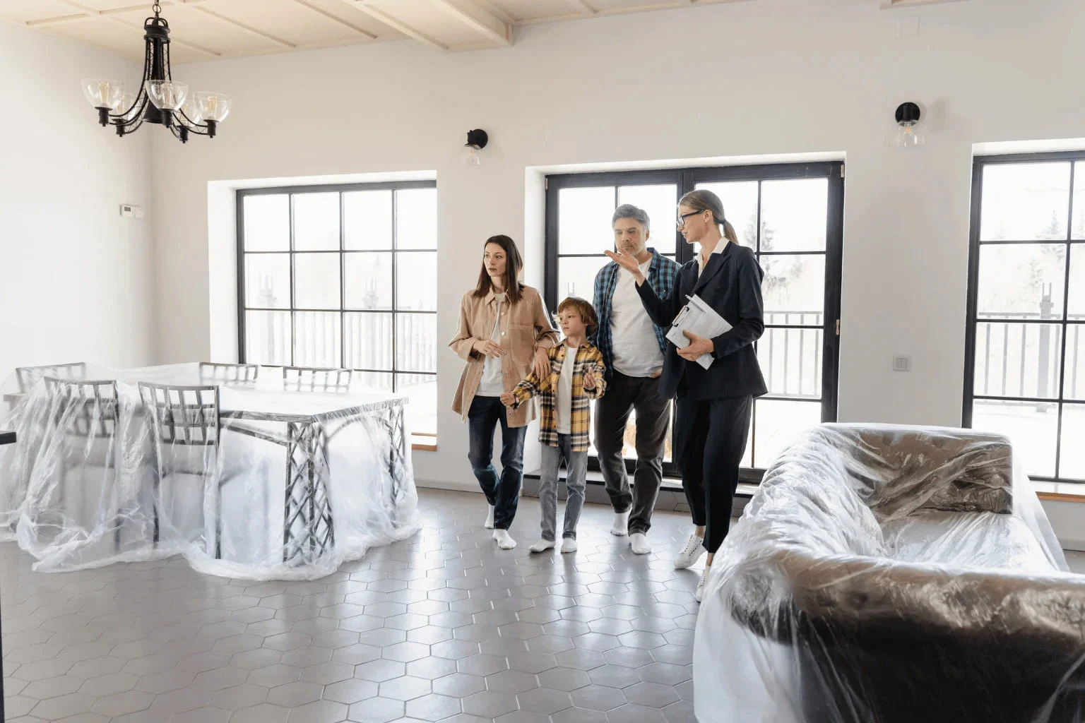 real estate agent showing home to a family