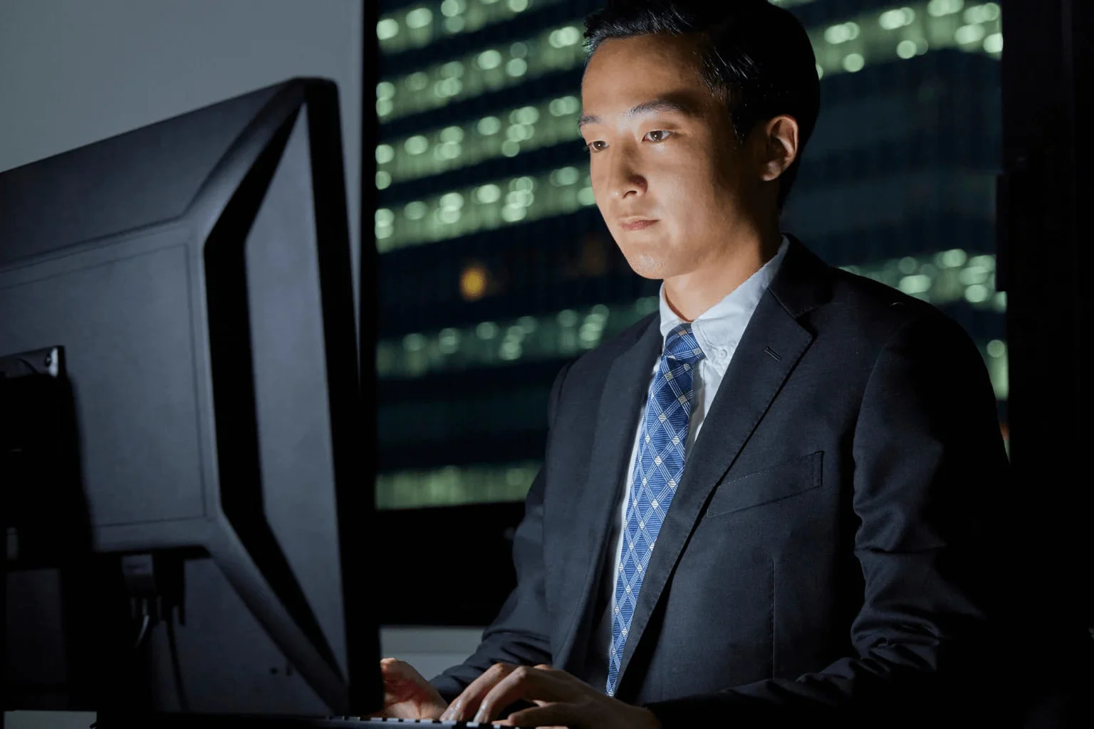 Realtor working on computer during evening hours