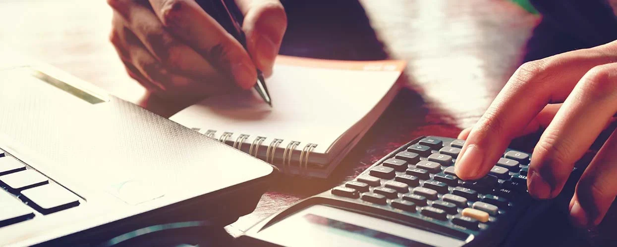 person budgeting on a paper